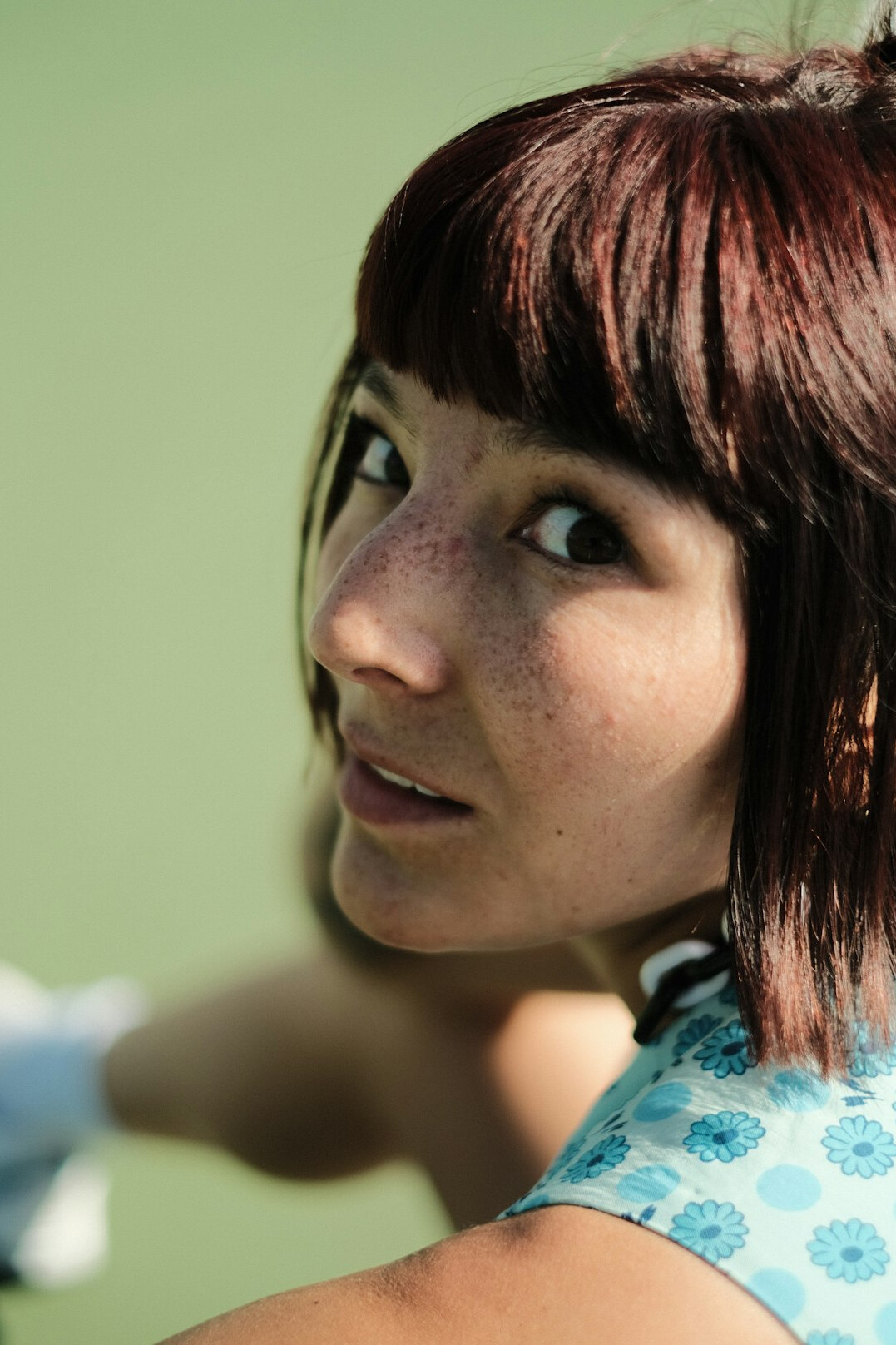 Portrait of a young woman with short light brown hair smiling