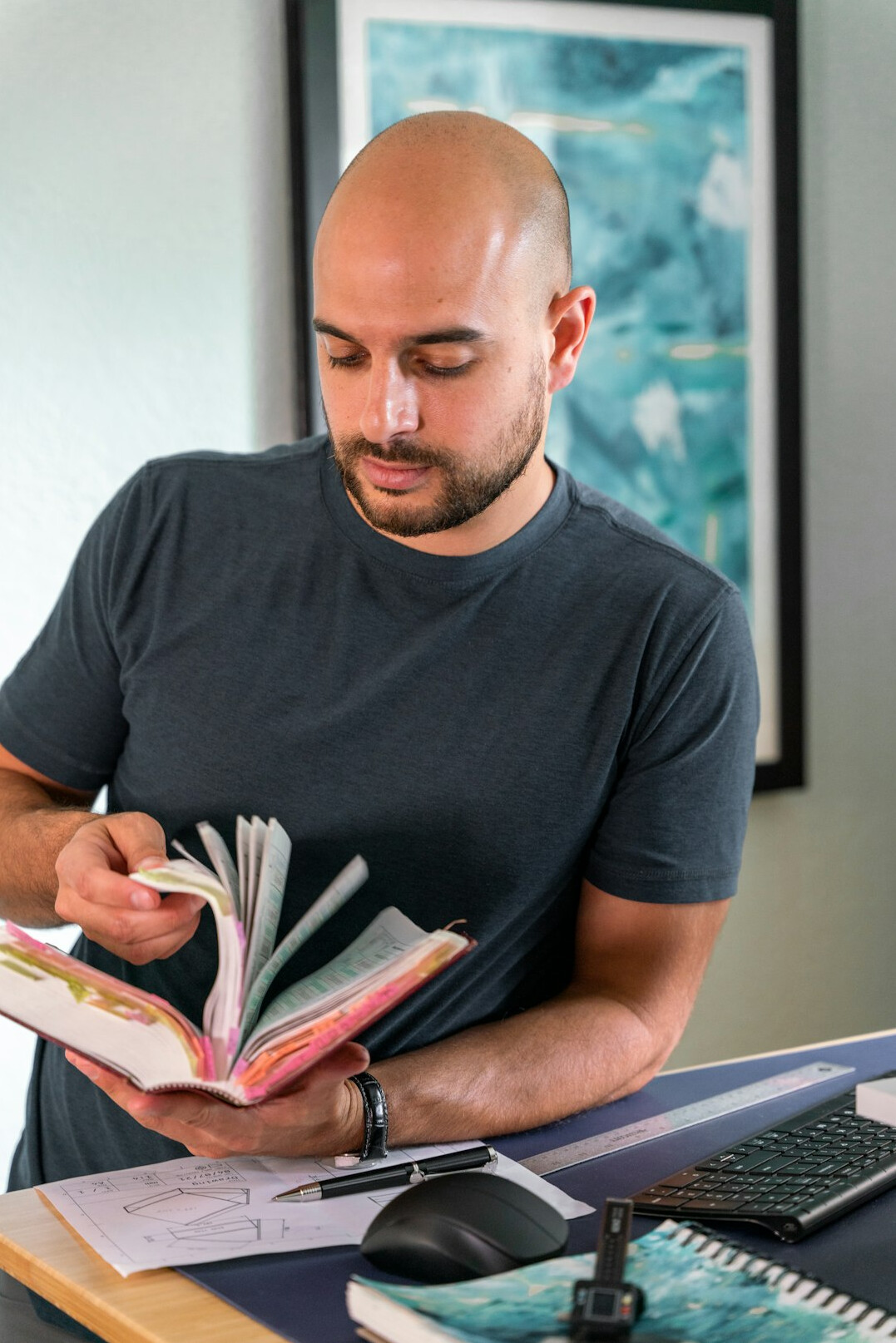 person reading book in office